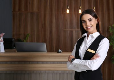 Portrait,Of,Receptionist,At,Desk,In,Lobby